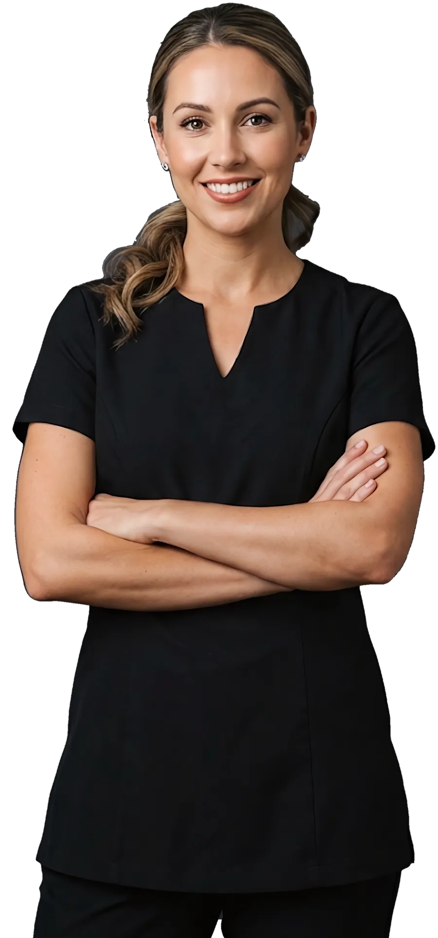 A beauty therapist in a black uniform, arms crossed, smiling
