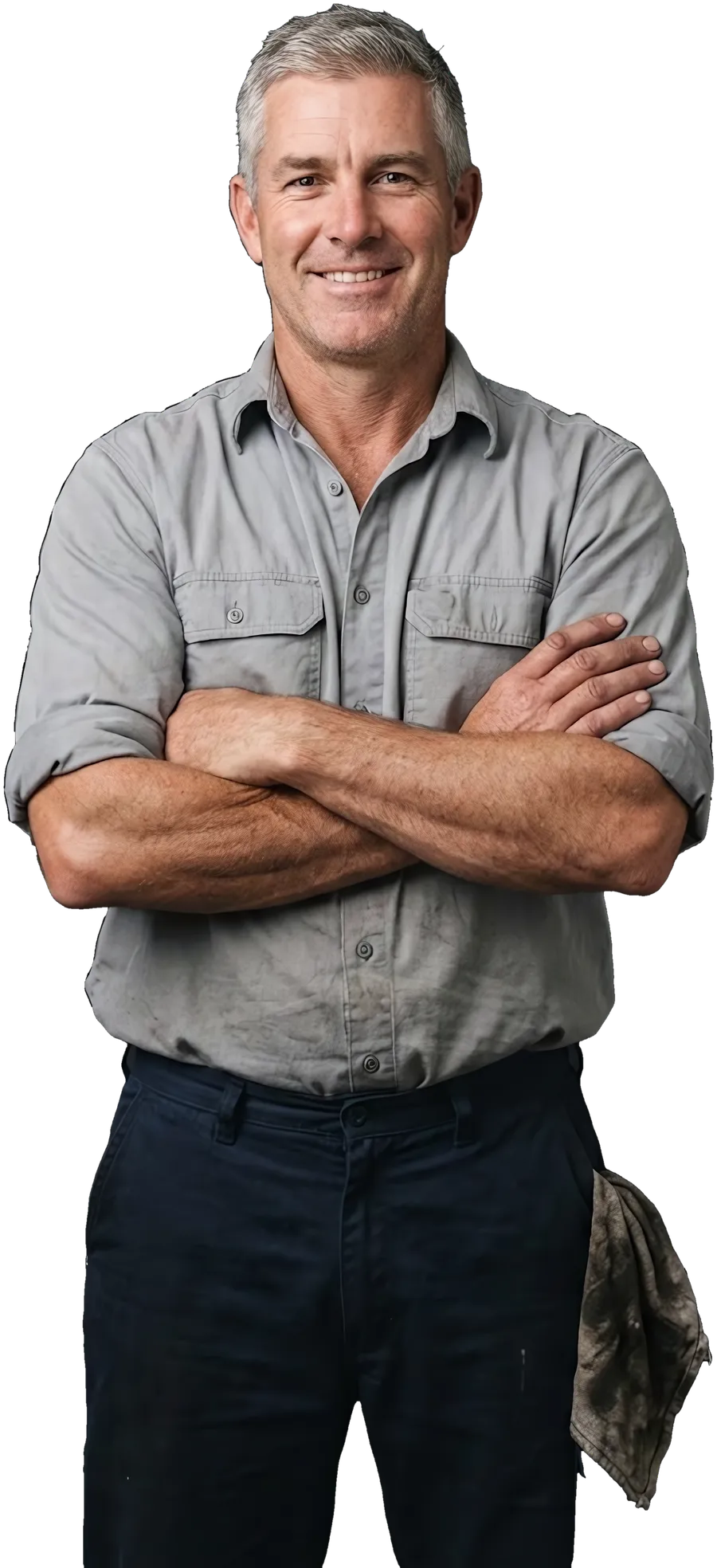 A mechanic in a work shirt, arms crossed, smiling